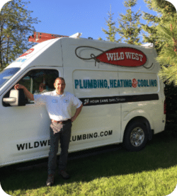 Service man posing in front of service truck